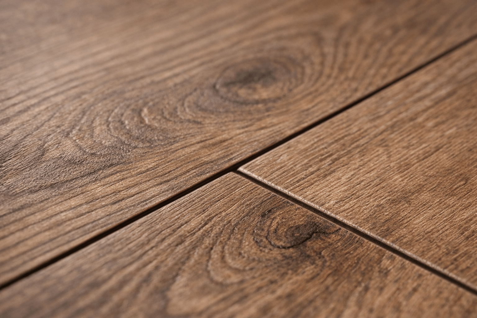 wood laminate flooring, Macro close-up of wood-look laminate showing embossed-in-register grain texture and a micro-beveled edge
